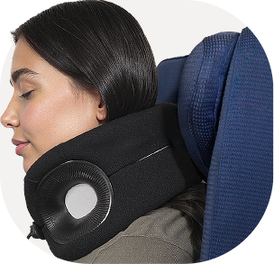 Person in airplane seat comfortably using a Cabeau Evolution X neck pillow 