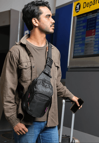 Man wearing On - The - Go Sling Pack in an airport